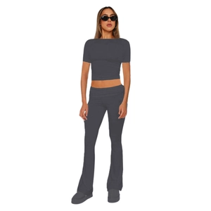 Detail of dark grey two-piece set featuring short sleeve crop top and flared trousers