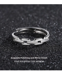 Macro shot of polished silver chain ring with mirror finish on black glitter background