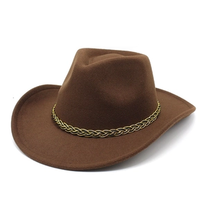 Detailed macro view of dark brown western felt hat featuring a black and gold braided band