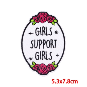 Macro detail of oval Girls Support Girls embroidered patch with rose embroidery and size specs