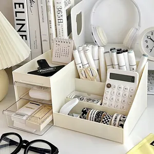 Cream desk organizer with tilted pen slots and transparent drawers for stationery storage