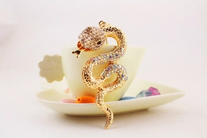 Detailed view of snake-shaped keychain featuring sparkling colorful rhinestones and gold plating