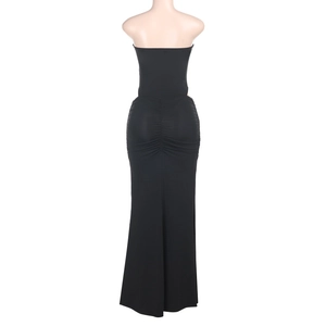 Detail view of the back of a black bodycon tube dress with ruching detail on the hip
