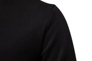 Close-up of the fine knit texture and shoulder seam stitching on a black sweatshirt