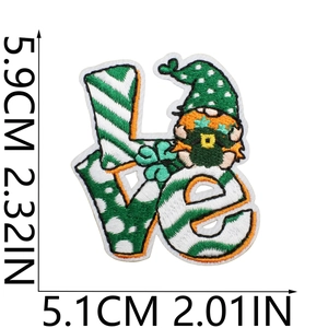 Macro detail of LOVE embroidered patch showing clover gnome and exact 5.9cm height