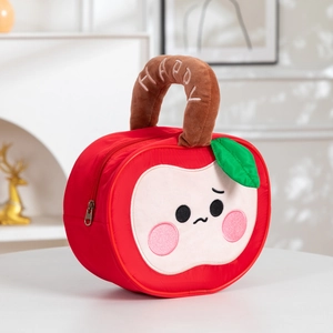 Detail of red apple-shaped gift bag with happy embroidery and cute cartoon face