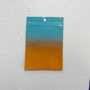 Close-up of blue orange gradient resealable bag with hanging hole and zipper lock