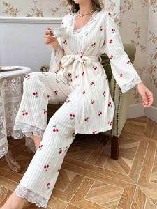 Detail of cherry print pajamas with lace edges and ribbed texture on cozy homewear set