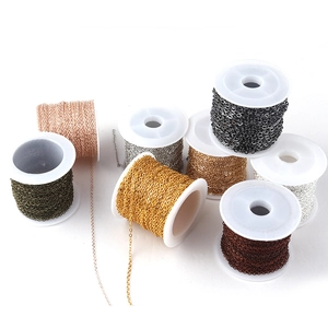 Flat O-shaped copper jewelry chains in assorted metallic finishes on white spools