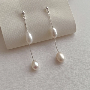 Elegant S925 silver long tassel earrings with white freshwater pearls on silk background
