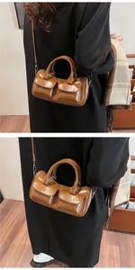 Brown polished leather saddle bag with double flap pockets and silver hardware detailing
