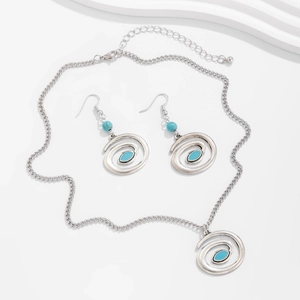 Detailed set of bohemian silver necklace and earrings with turquoise beads on white background