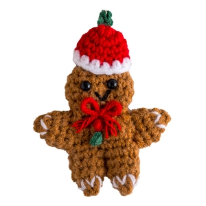 Handmade crochet gingerbread man keychain with red Christmas hat and bow tie