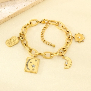 Detail of 18K gold-plated stainless steel bracelet with moon and star pavé charms