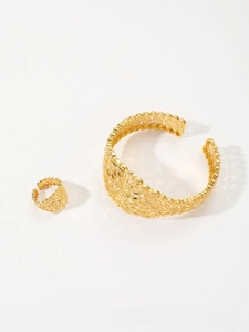 Detail of gold-plated leaf pattern hollow bangle and matching adjustable ring jewelry set
