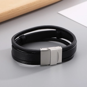 Detail of multi-layer black leather bracelet with brushed stainless steel magnetic clasp