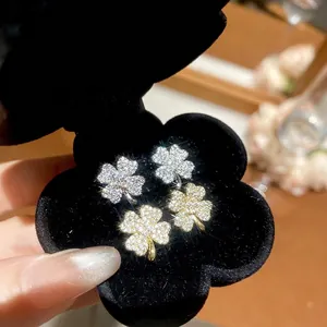 Sparkling clover flower stud earrings with zircon in silver and gold plated finishes