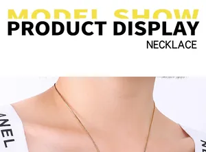 Close-up of a minimalist golden box chain necklace worn by a model on white background