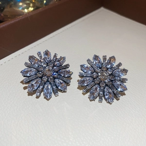 Macro shot of silver flower earrings with radiant marquise-cut rhinestones detail