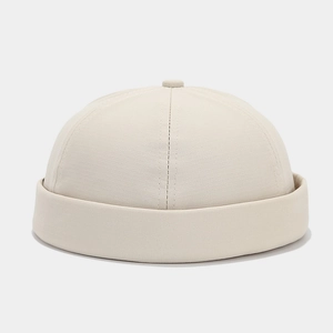 Detail of beige docker hat showing fabric texture and six-panel stitching design