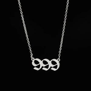 Macro shot of silver 999 angel number pendant on O-chain with hip-hop style