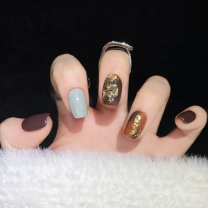 Handmade brown and amber press-on nails with gold foil and large gemstone details