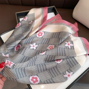 Close-up of pink flower print silk scarf draped over a classic picture frame
