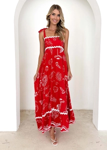Detail of red floral sundress with Ciao print and white graphics in a minimalist setting