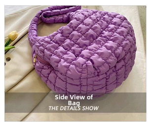 Detail view of purple quilted cloud bag showing smooth texture and metallic zipper finish