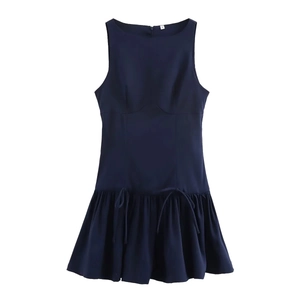 Detail of navy blue sleeveless dress featuring a waist tie and pleated flared hem