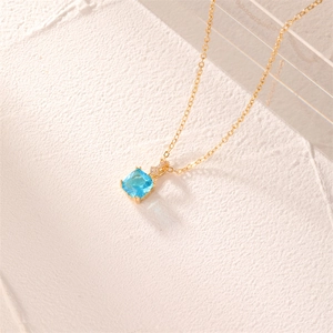Elegant gold necklace with square blue gemstone pendant and micro-diamond accents