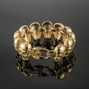 Detailed view of punk skull link bracelet in gold finish with secure snap buckle closure