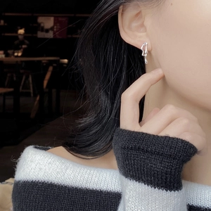 Minimalist irregular liquid metal 925 silver earrings on model in soft lighting