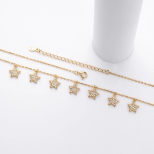 Macro shot of gold S925 silver star pendant with cubic zirconia inlay and lobster clasp