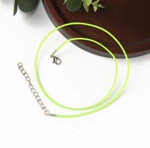 Detail of neon green wax cord necklace with silver lobster clasp and extender chain