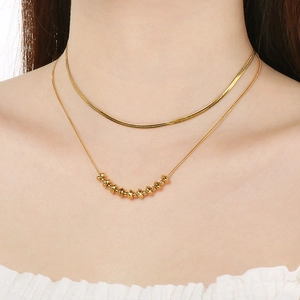 Double-layered golden stainless steel Y-necklace with bead charms and sleek snake chain