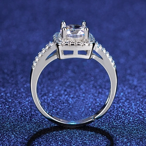 Detailed close-up of a silver halo ring with a round brilliant cut stone and side pave diamonds
