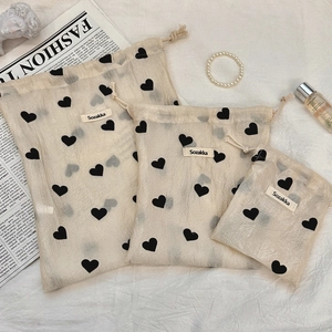 Three-piece champagne heart drawstring storage bags in various sizes with brand label