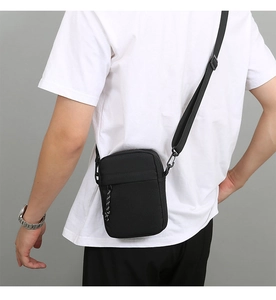 Men's black nylon cross-body bag with adjustable shoulder strap and rope detail