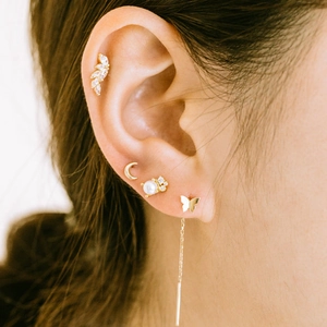 Detail of S925 sterling silver ear cuff set with leaf and crown pearl studs on model