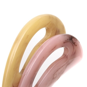 Set of marble texture resin hair clips in pale yellow and pink on a white background