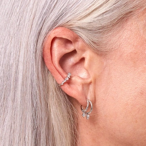 Minimalist S925 silver ear cuffs and double zircon hoop earrings worn by a female model