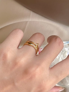 Close-up of golden S925 silver double-layered ring with heart detail and bead texture
