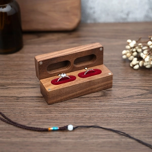 Macro detail of walnut wood double ring box with red velvet lining and magnetic closure