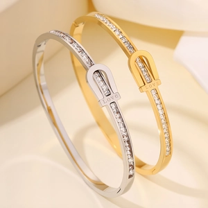 Luxe titanium steel horseshoe buckle bracelet with LOVE engraving and white cubic zirconia