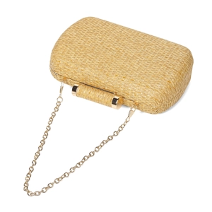 Detailed view of handmade woven straw evening clutch with elegant gold chain strap