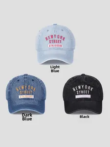 Close-up of embroidered New York Street lettering on washed denim baseball caps
