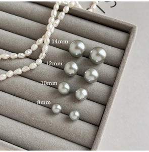 Detail showing various sizes of grey pearls from 8mm to 14mm on a velvet jewelry tray