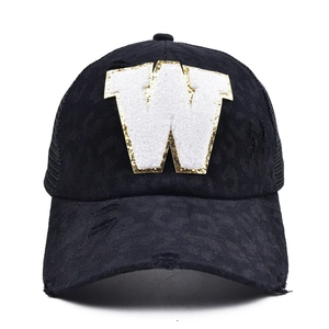 Black ponytail baseball cap with leopard W patch, distressed finish and mesh back