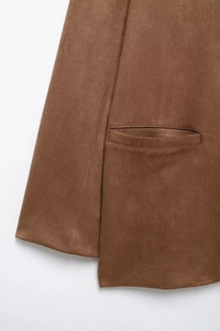 Detail of brown fabric texture and pocket flap on the warm fleece two-piece suit